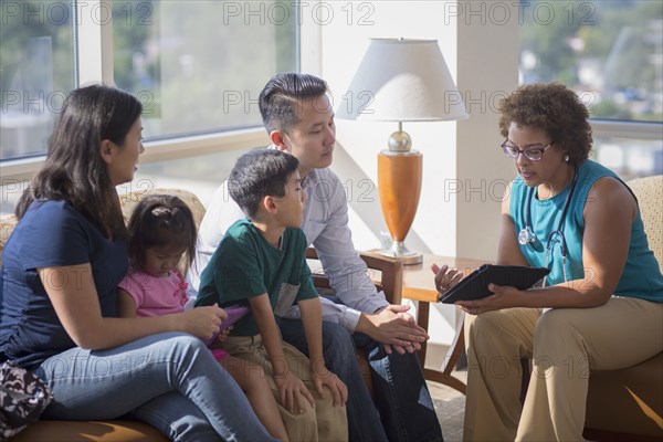 Doctor and patients using digital tablet