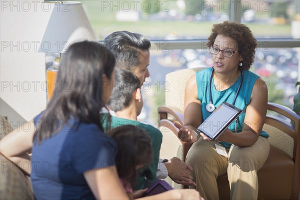 Doctor and patients using digital tablet