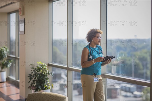 African American doctor using digital tablet