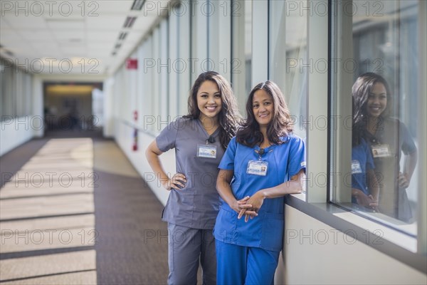 Nurses smiling in hospital hallway