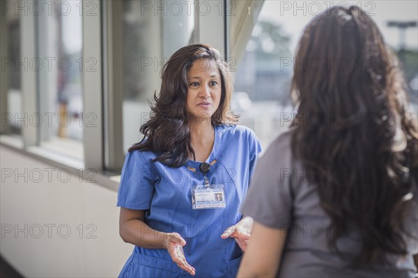 Nurses talking in hospital hallway