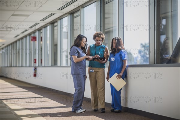 Nurses and doctor using digital tablet