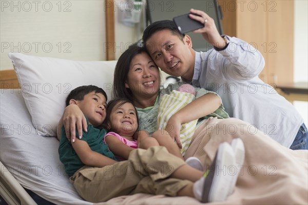 Family taking selfie with newborn baby