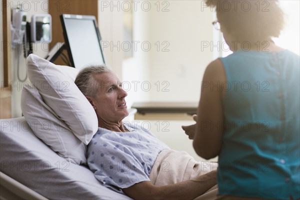 Doctor talking to patient in hotel room