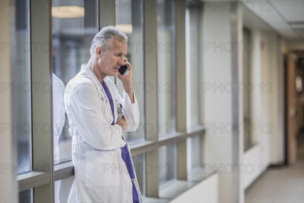 Caucasian doctor talking on cell phone