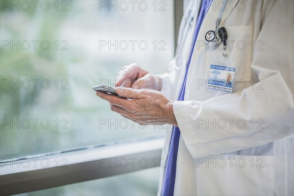 Caucasian doctor using cell phone