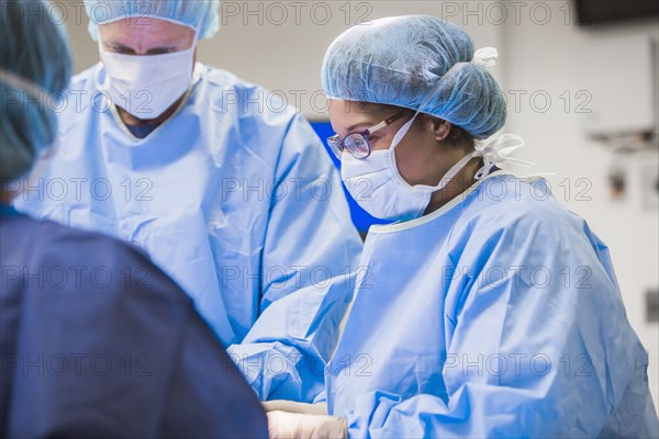 Surgeons working in operating room