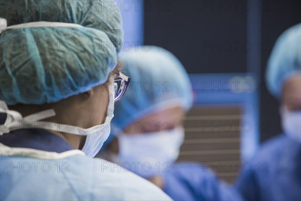 Surgeons working in operating room