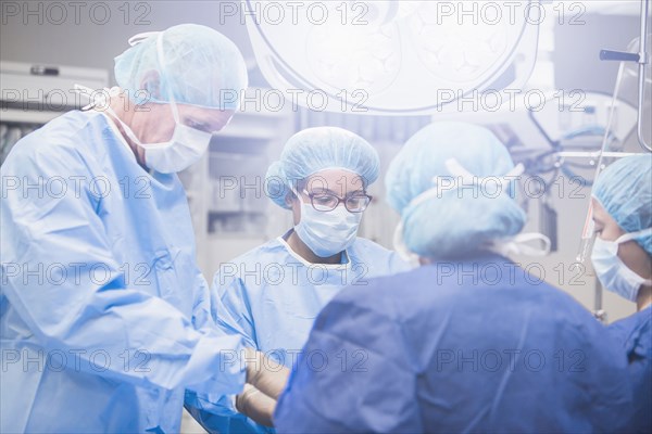 Surgeons working in operating room