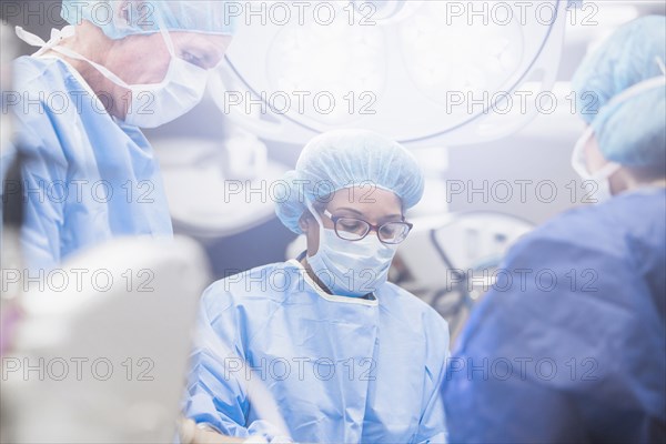 Surgeons working in operating room