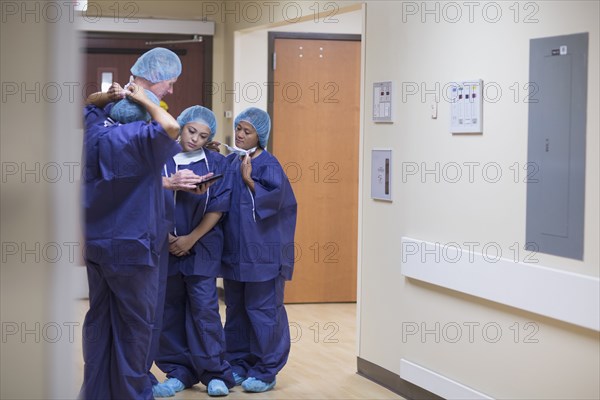 Surgeons talking in hospital hallway