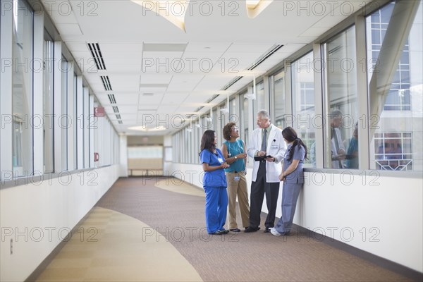 Doctor and nurses talking in hospital hallway