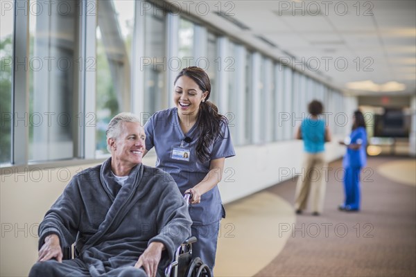 Nurse pushing patient in wheelchair