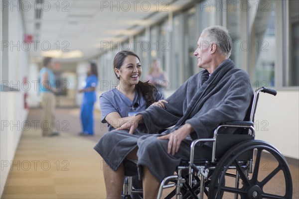 Nurse talking to patient in wheelchair