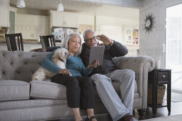 Older couple video chatting with digital tablet