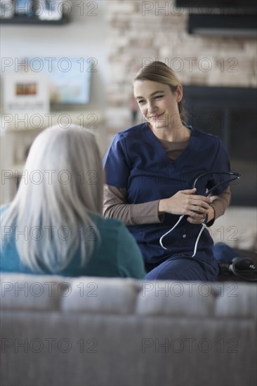 Nurse talking to patient in living room