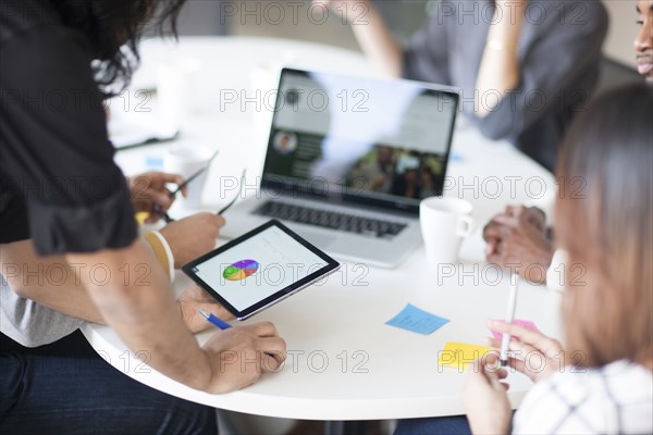 Business people using digital tablet in office meeting