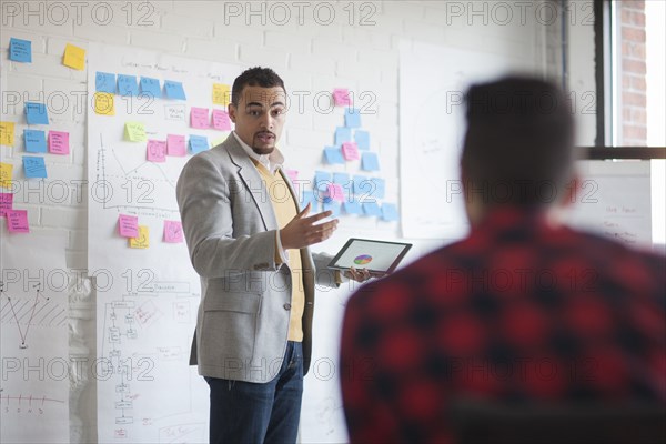 Businessmen talking in office meeting