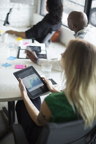 Businesswoman using digital tablet in office meeting