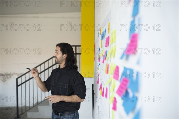 Mixed race businessman talking in office meeting