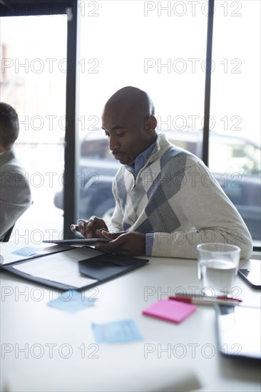 Businessman using digital tablet in office meeting