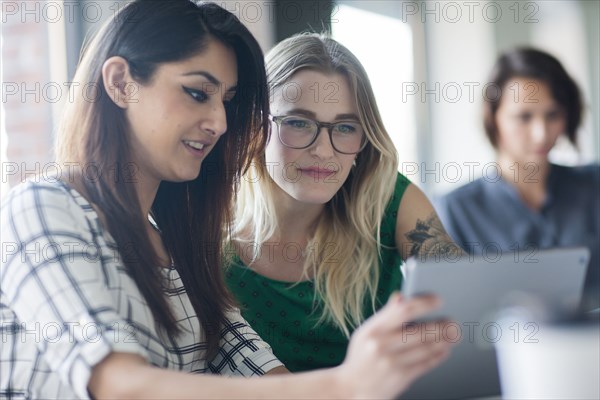 Businesswomen using digital tablet in office