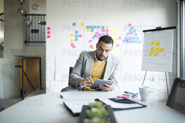 Businessman using digital tablet in office