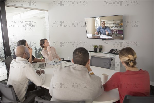 Business people video conferencing in meeting