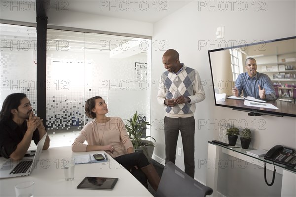 Business people video conferencing in meeting