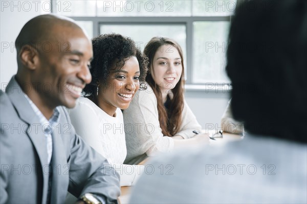 Business people laughing in meeting