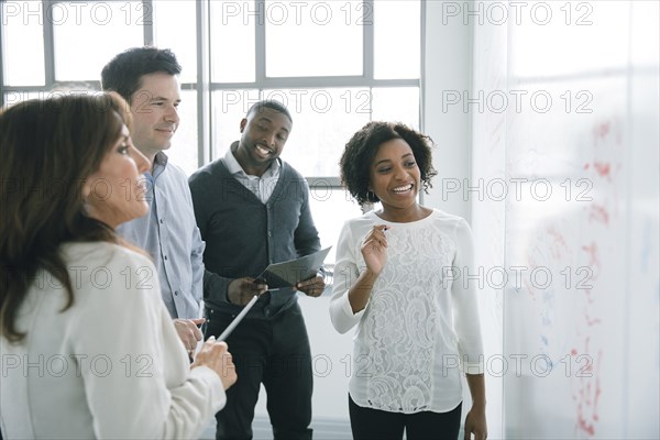 Business people reading whiteboard in meeting