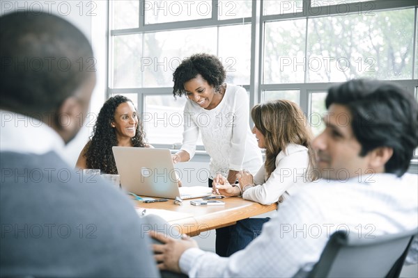 Businesswomen using laptop in meeting