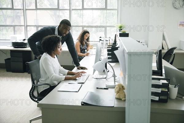 Business people using computer in office