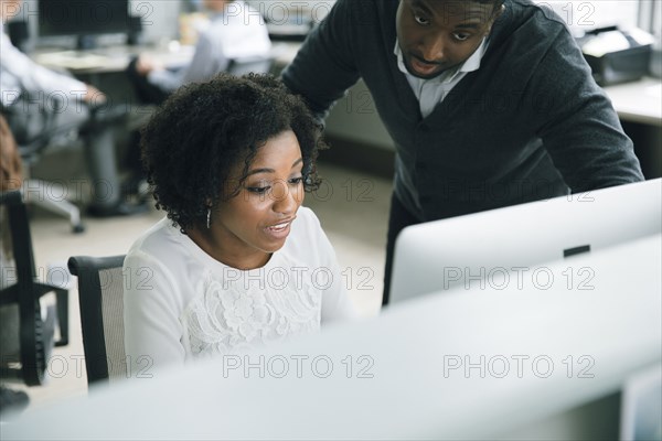 Business people using computer in office