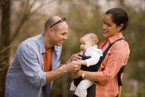 Hispanic family with baby in park