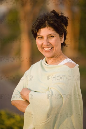 Hispanic woman with arms crossed