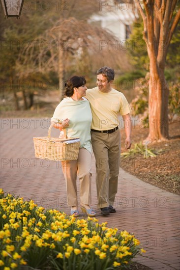 Hispanic couple walking in park