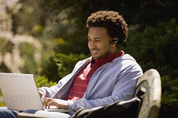 African American man typing on laptop