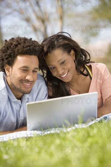 African American couple looking at laptop