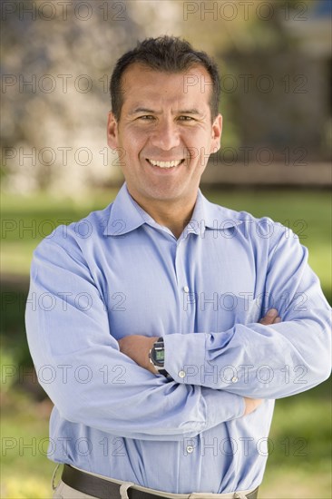Hispanic man with arms crossed