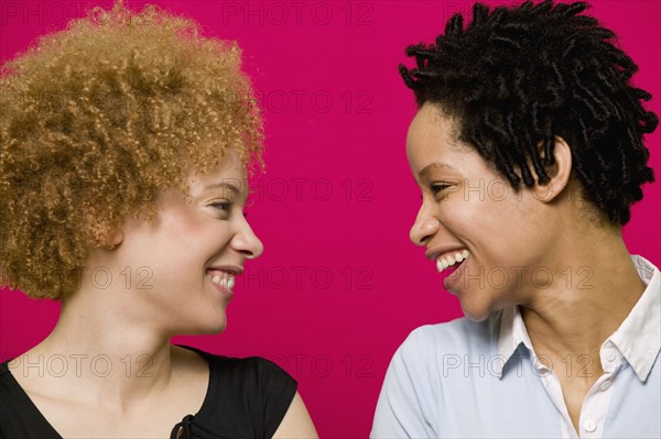 African women smiling at each other