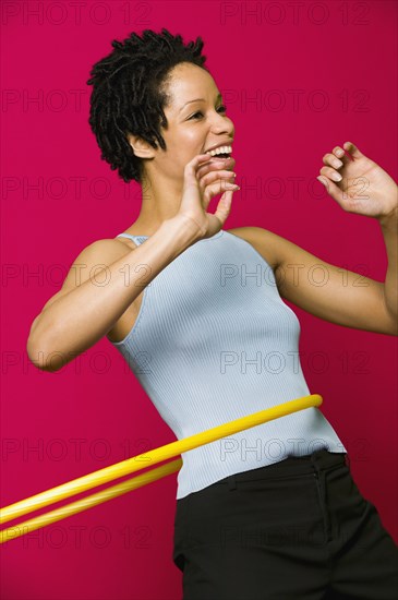 African woman playing with plastic hoop