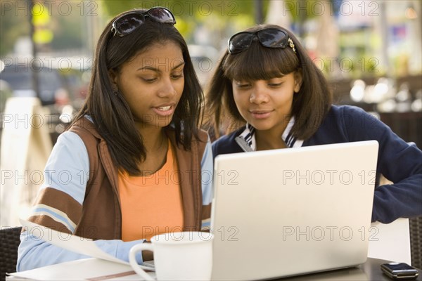 African teenaged girls looking at laptop