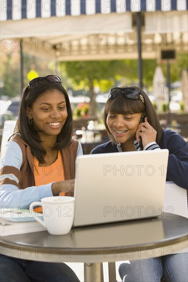 African teenaged girls looking at laptop