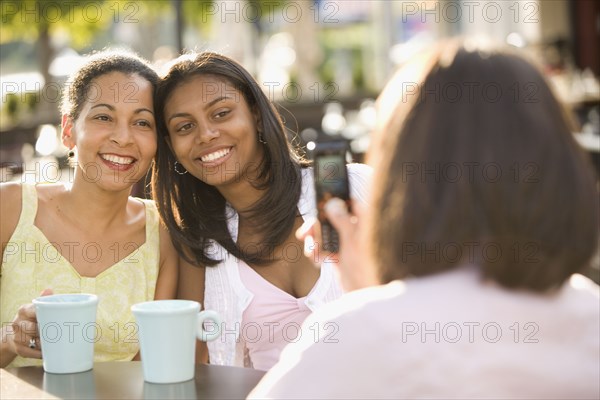 African mother and daughter having photograph taken