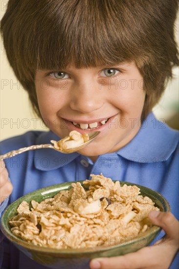 Hispanic boy eating cereal