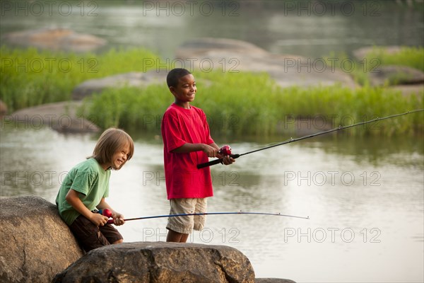 Smiling boys fishing together