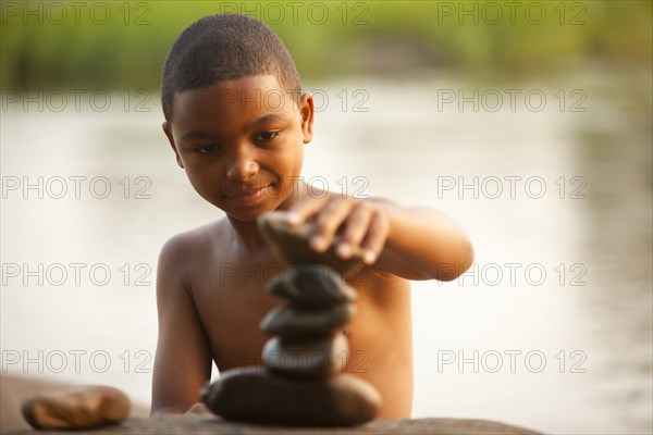 African American boy stacking rocks