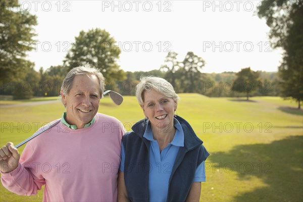 Couple standing on golf course