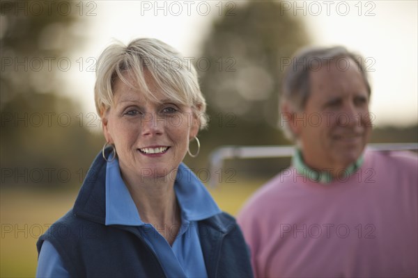 Couple standing on golf course